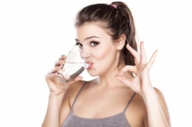 La fille boit de l'eau propre